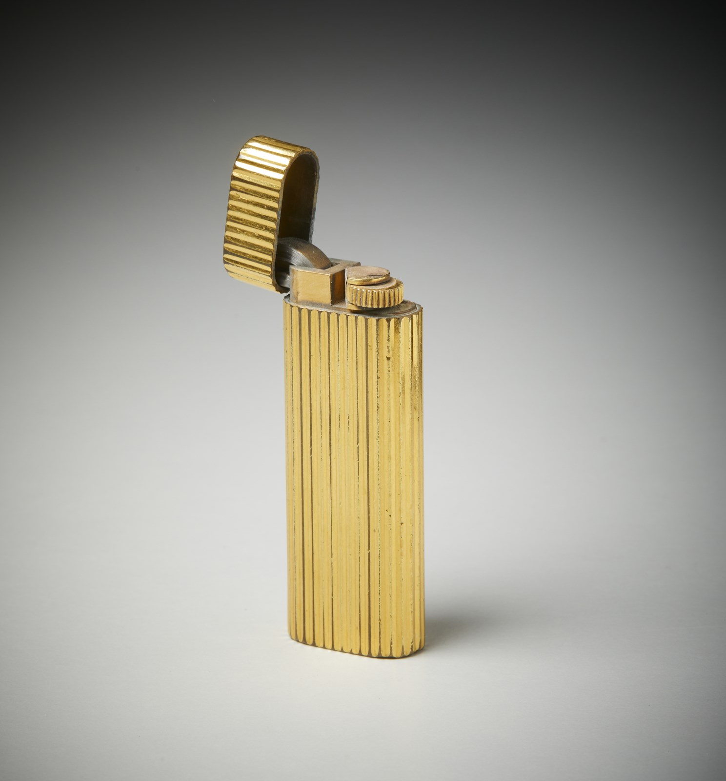 Yellow gold plated pocket lighter.  ( Cartier)
