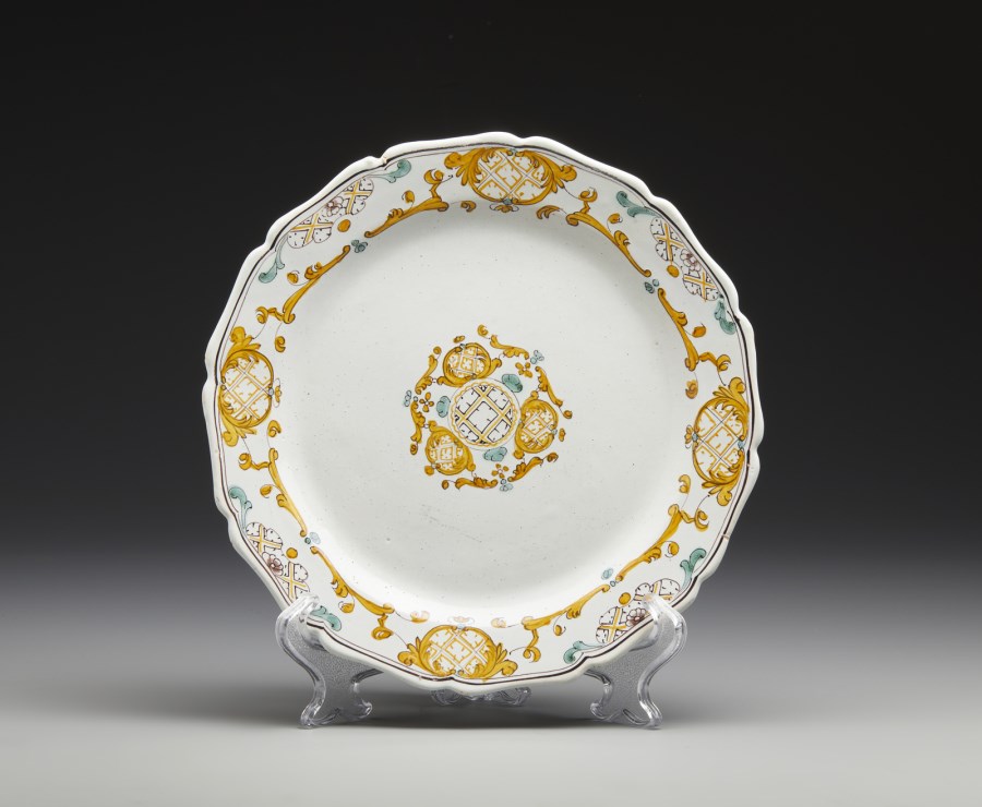 A polychrome maiolica circular plate with 'broderie' decoration in shades of orange, green and brown ( Real Fabbrica Di San Carlo, Caserta, 1750-1760)